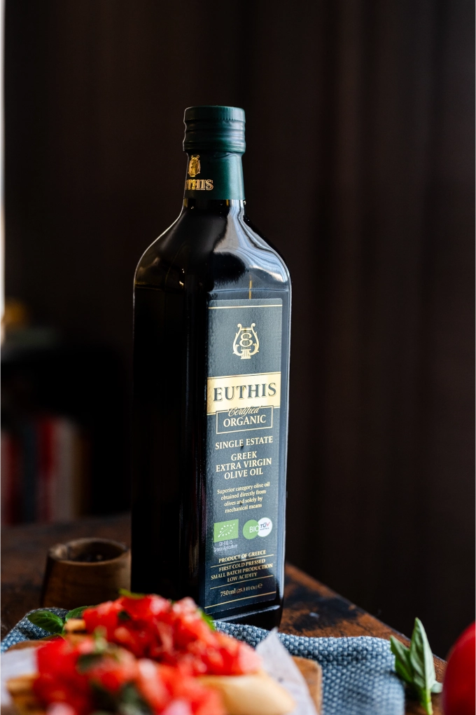 Euthis Organic Extra Virgin Olive Oil bottle with fresh Bruschetta Romana